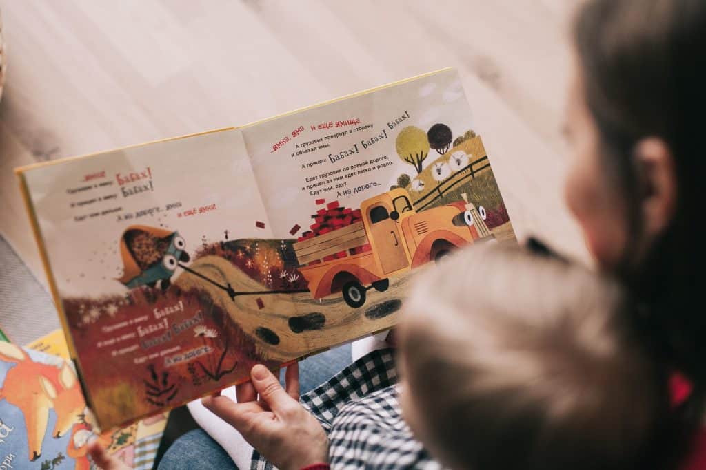 woman reading book to toddler 1741231 scaled